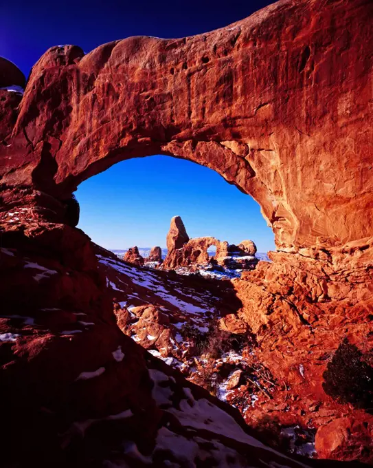 Turret Arch viewed through the North Window in winter, The Windows Section, Arches National Park, Utah.