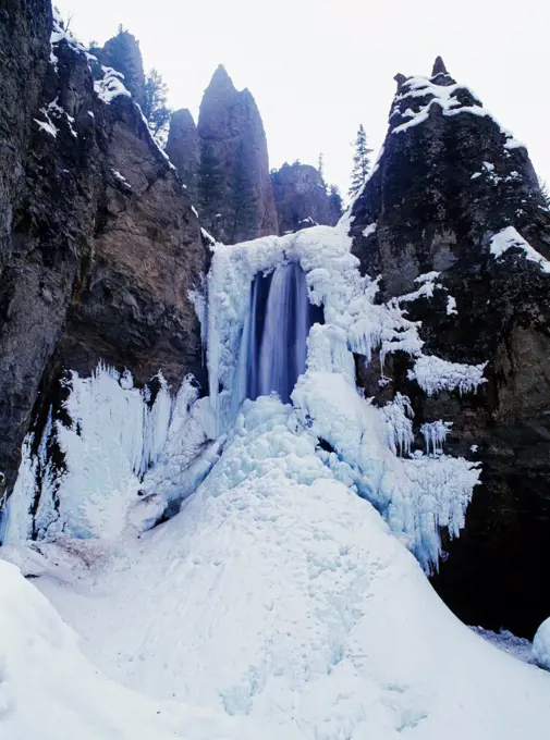 USA, Wyoming, Yellowstone National Park, Tower Fall draped in ice during winter