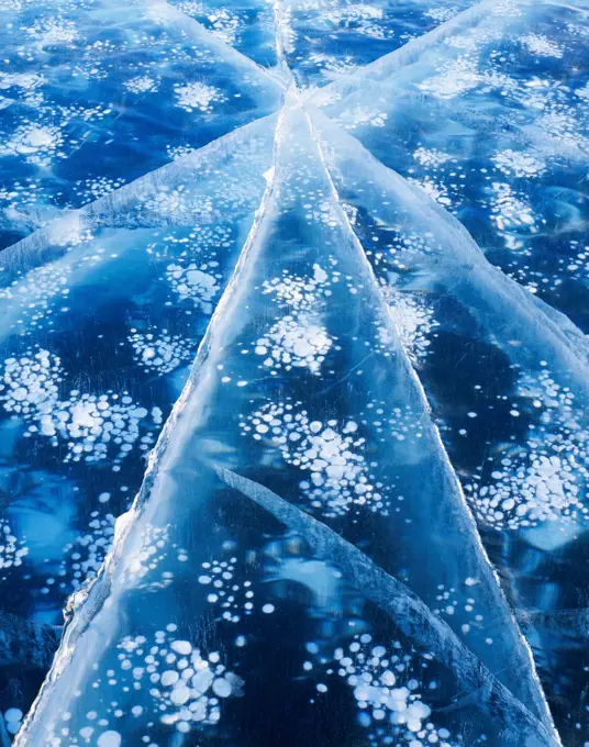 Abstract pattern of air bubbles and cracks in thick ice of Cottonwood Lake, Matanuska Valley, Alaska.