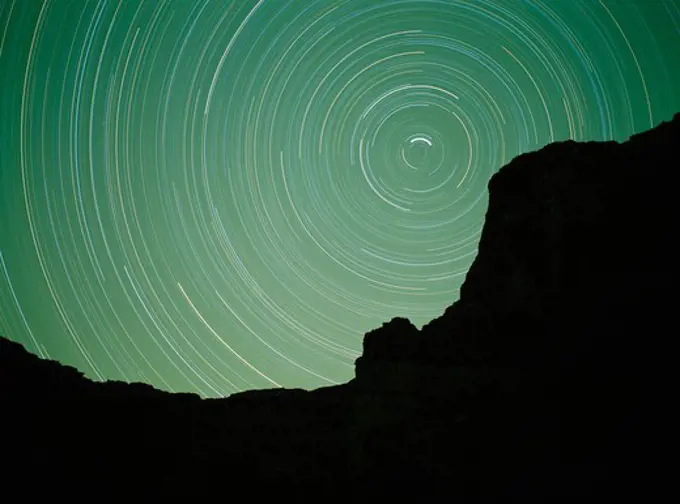 Night exposure of star trails circling Polaris, The North Star, above Butte Point near Blacktail Canyon, Grand Canyon, Grand Canyon National Park, Arizona.