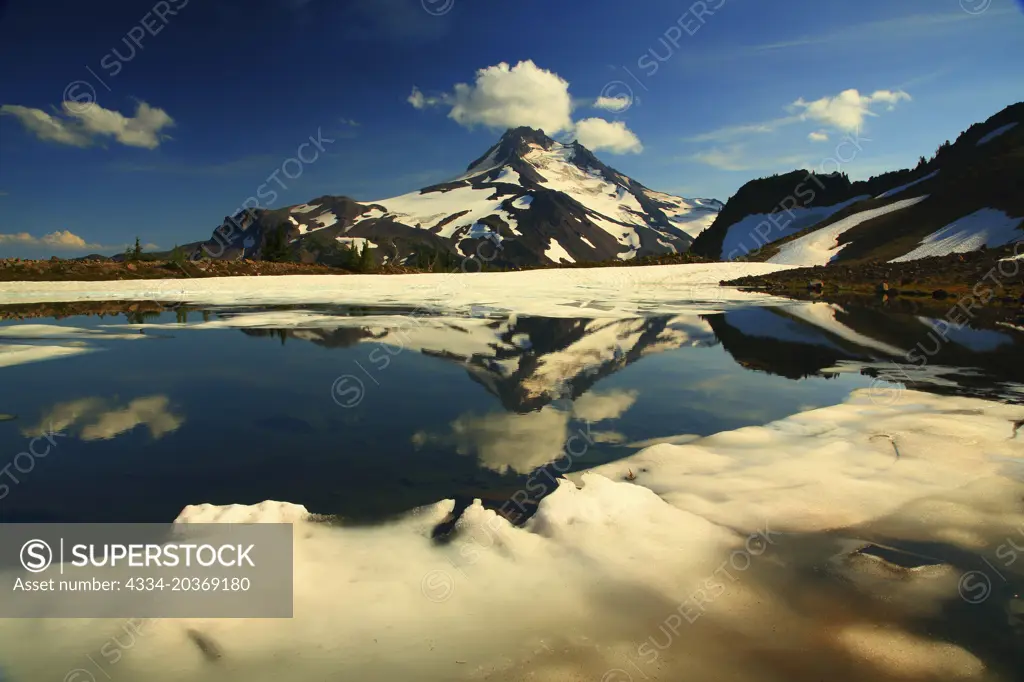 Mt Jefferson Reflected in a Partailly Frozen Tarn Above Jefferson Park in the Mt Jefferson Wilderness in Oregon