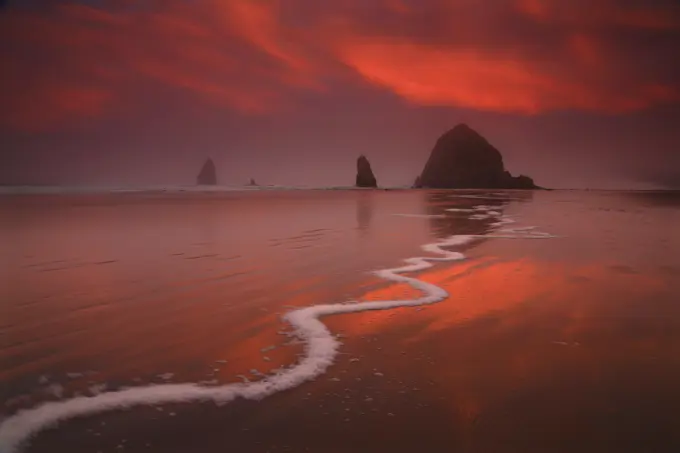 Crazy Sunrise Light Over Haystack Rock and The Needles From Cannon Beach in Oregon