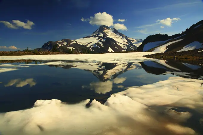 Mt Jefferson Reflected in a Partailly Frozen Tarn Above Jefferson Park in the Mt Jefferson Wilderness in Oregon