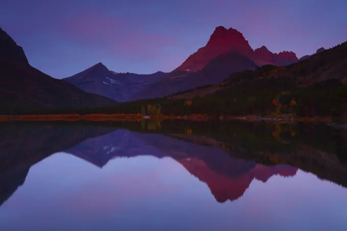 Sunrise Light on Mt Wilbur Reflected in Swift Current Lake in the Many Glacier Region of Glacier National Park in Montana