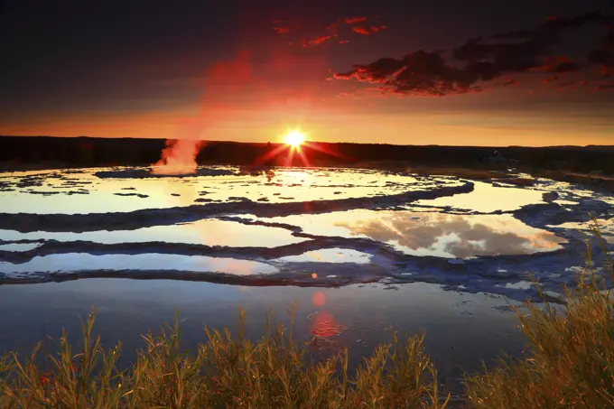 Sunset Reflected in Great Fountain Geyser Terrace Pools in Yellowstone National Park in Wyoming