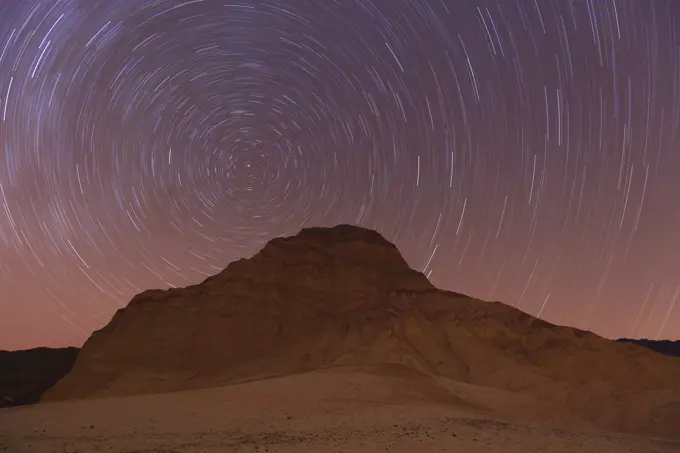 Star Trails with the North Star and the Manly Beacon in the Alluvial Fans in the Bad Lands of Death Valley National Park in California