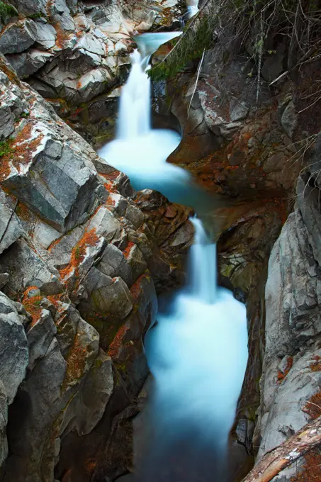 Waterfalls cascade through rugged rocks on Van Trump Creek, in Mount Rainier National Park.