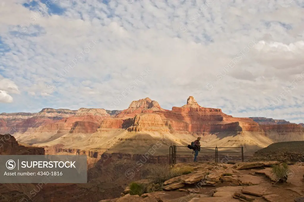 A man hiking the Bright Angel Trail looks out over the Grand Canyon, south rim, Grand Canyon National Park, Arizona