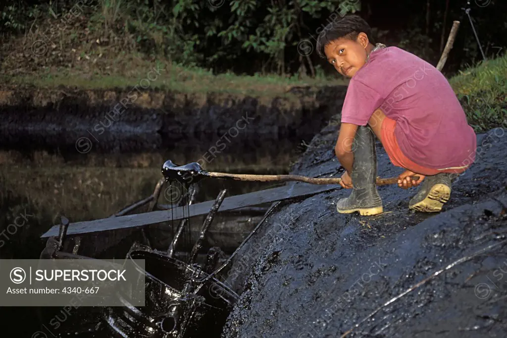 Woarani Boy by Open Crude Oil Pit