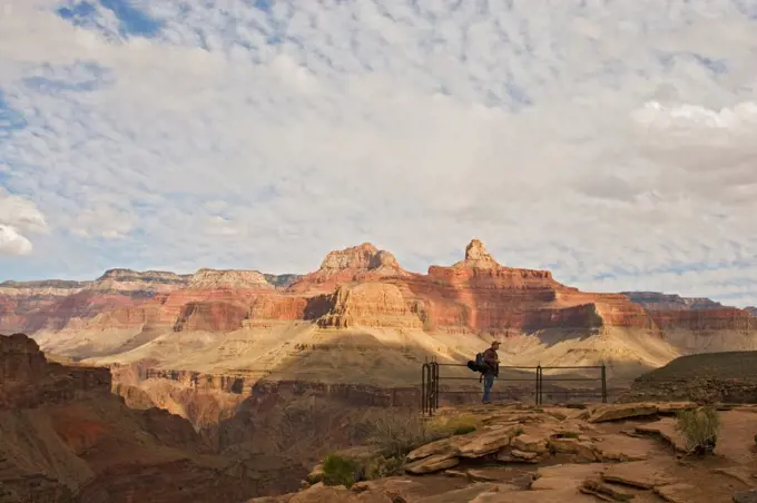 A man hiking the Bright Angel Trail looks out over the Grand Canyon, south rim, Grand Canyon National Park, Arizona