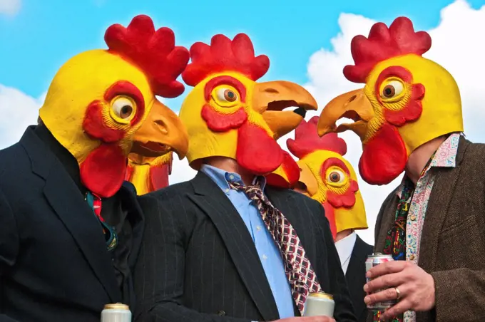 A group of men in business suits and loud ties wearing rubber chicken heads look confused at one another.