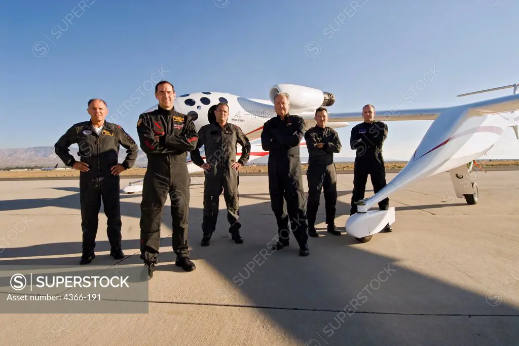 The six test pilots of Scaled Composites stand with White Knight One on the ramp at Mojave Airport in Mojave, California. They include (from L to R) Mike Melvill, Brian Binnie, Peter Siebold, Doug Shane, Mike Alsbury, and Matt Steinmetz.