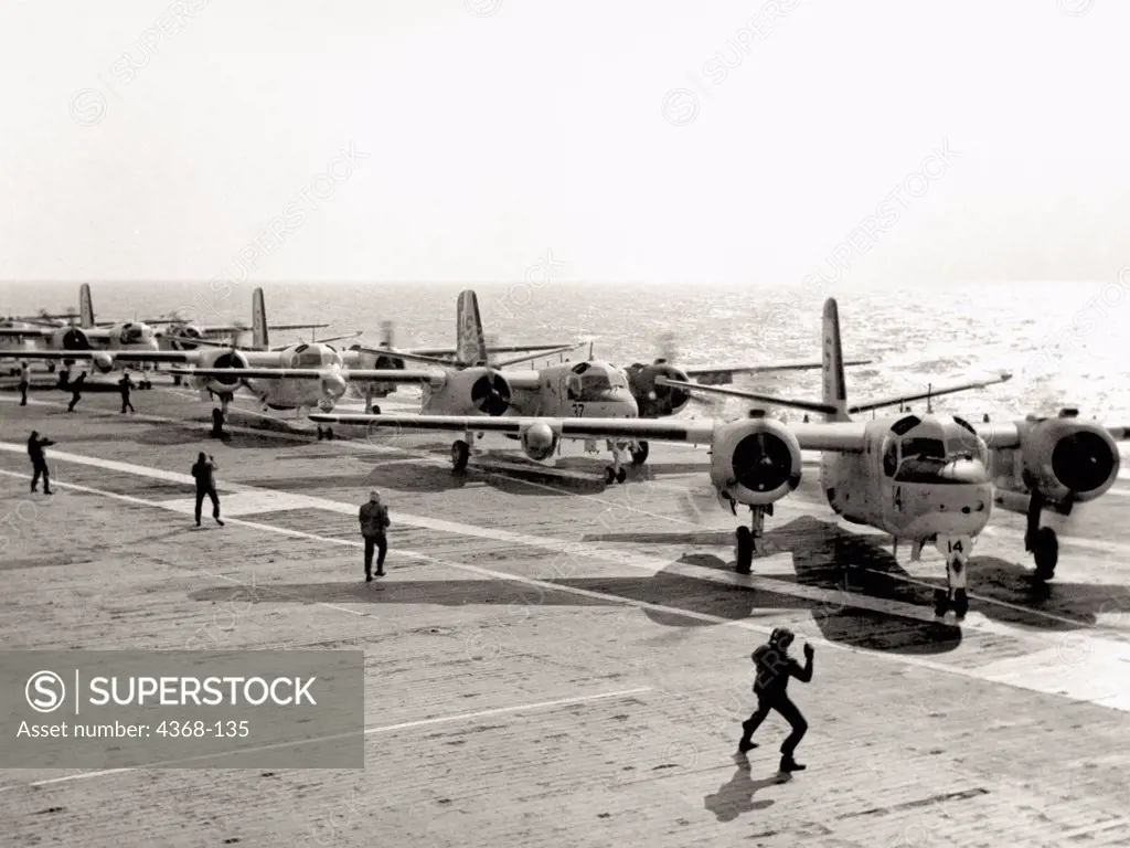 Naval C1 Tracker aircraft on flight deck of the USS Wasp, preparing for takeoff.  These propeller-operated WWII vintage aircraft were used as anti-submarine aircraft. The Grumman TFC1A first flew in 1955 and was used for passengers, cargo and mail.