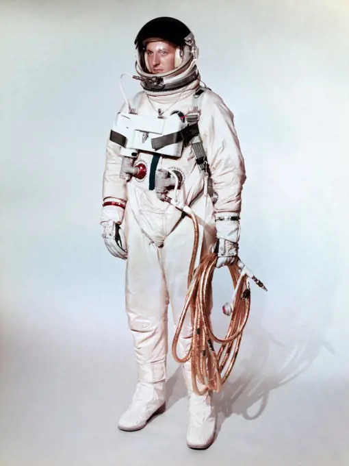 Extravehicular space suite worn by a Gemini 4 astronaut is shown on a test subject.  Gold coated umbilical connects the astronaut to the Gemini spacecraft.