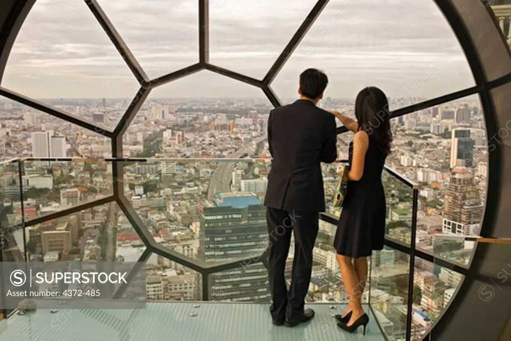 A couple at the award-winning Breeze Restaurant, at top of Lebua at State Tower, Silom Road, Bangkok, Thailand.