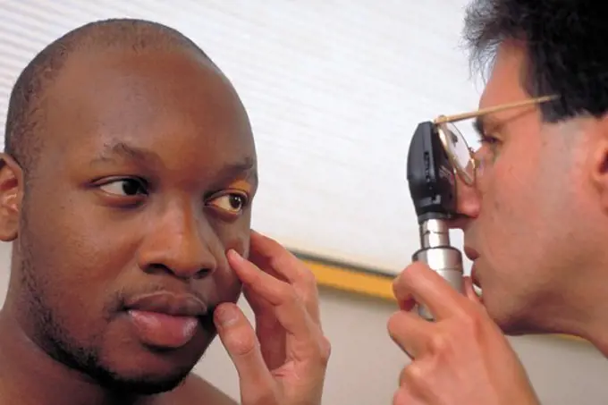 Doctor Examining Patient with Ophthalmoscope