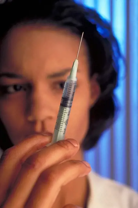 Young Female Doctor with Syringe