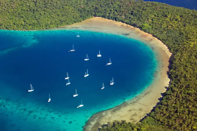 Boats anchored in a cove of one of the islands of Tonga seen from the air, Kingdom of Tonga, South Pacific Ocean.