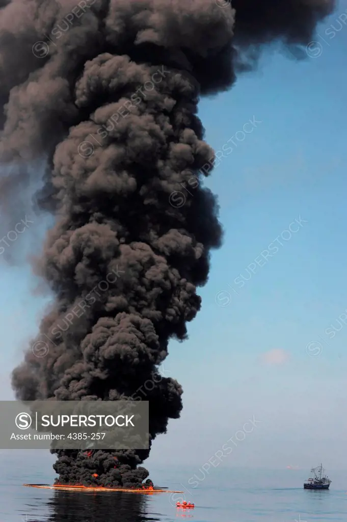 Gulf of Mexico (May 6, 2010) -- Dark clouds of smoke and fire emerge as oil burns during a controlled fire in the Gulf of Mexico. The U.S. Coast Guard working in partnership with BP PLC, local residents, and other federal agencies conducted the 'in situ burn' to aid in preventing the spread of oil following the April 20 explosion on Mobile Offshore Drilling Unit Deepwater Horizon.