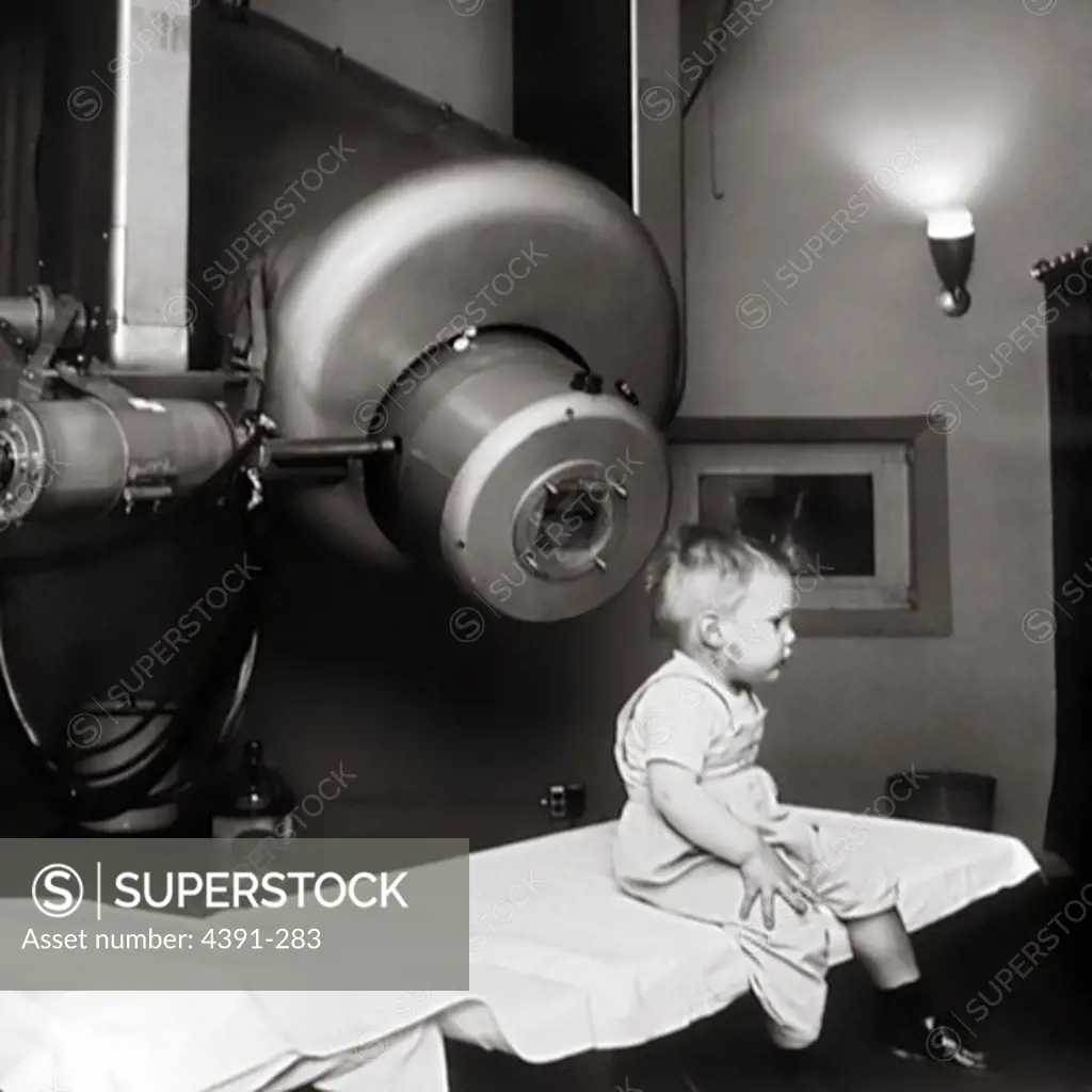 This is Gordon Isaacs, the first patient treated with the linear accelerator (radiation therapy) for retinoblastoma in 1957. Gordon's right eye was removed January 11, 1957 because the cancer had spread. His left eye, however, had only a localized tumor that prompted Henry Kaplan to try to treat it with the electron beam. Gordon's vision in the left eye was normal.