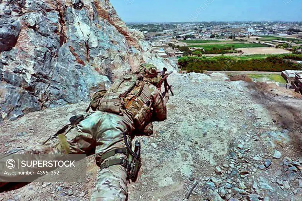 A sniper with Headquarters and Headquarters Company, 2nd Battalion, 8th Infantry Regiment, 2nd Brigade Combat Team, 4th Infantry Division observes and reports suspicious activity.