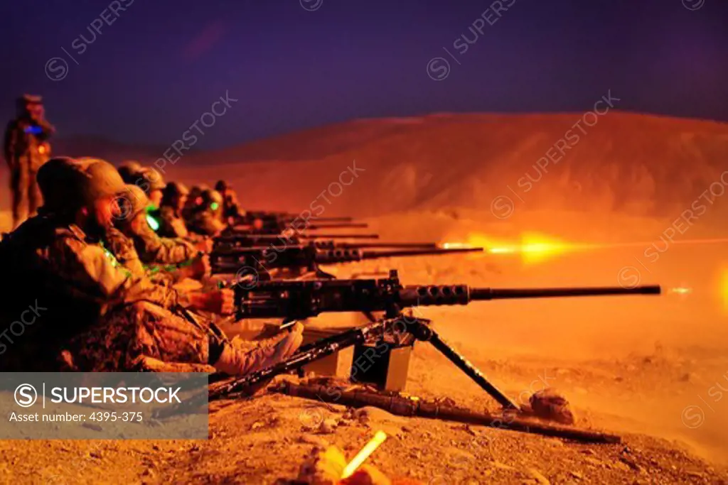 KABUL - Afghan National Army recruits fire the .50 cal. Heavy Machine Gun during a night exercise held at the Infantry Branch School, Camp Julien, 19 July. The exercise is the last live heavy weapons fire before graduation of bootcamp for the Afghan soldiers. (U.S. Navy photo by Petty Officer Michael James)