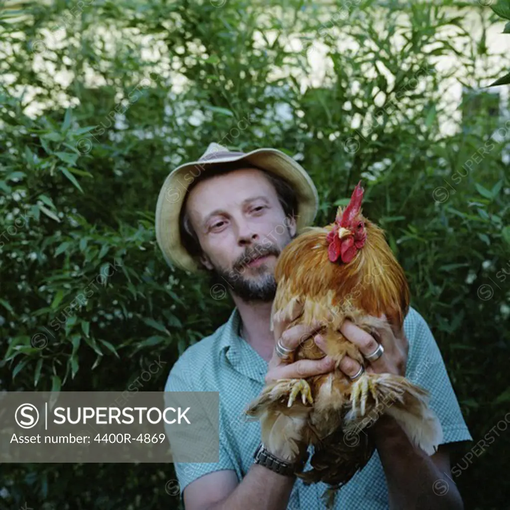 Man holding rooster