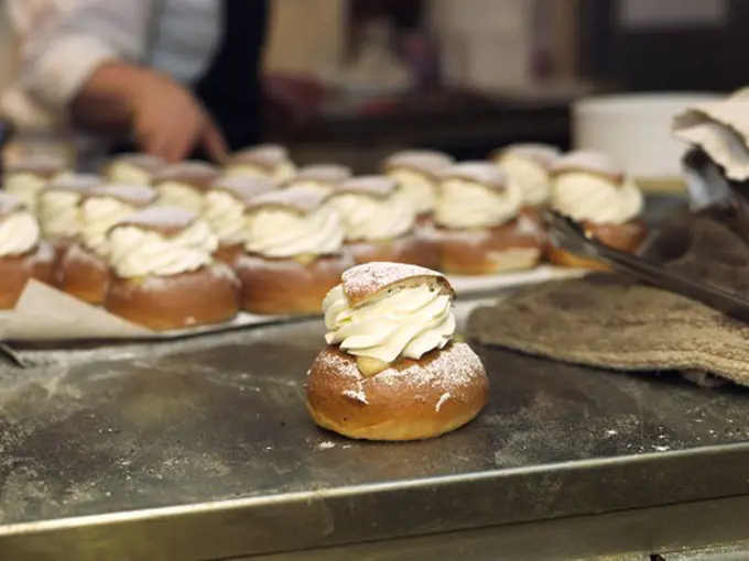 Cream buns with almond paste on a baking plate, Sweden.