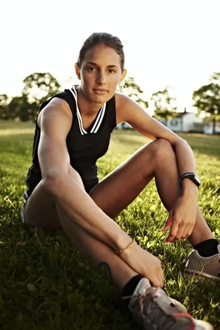 Young female runner relaxing, Sweden.