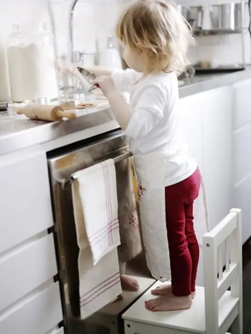 A little girl baking gingerbread, Sweden.