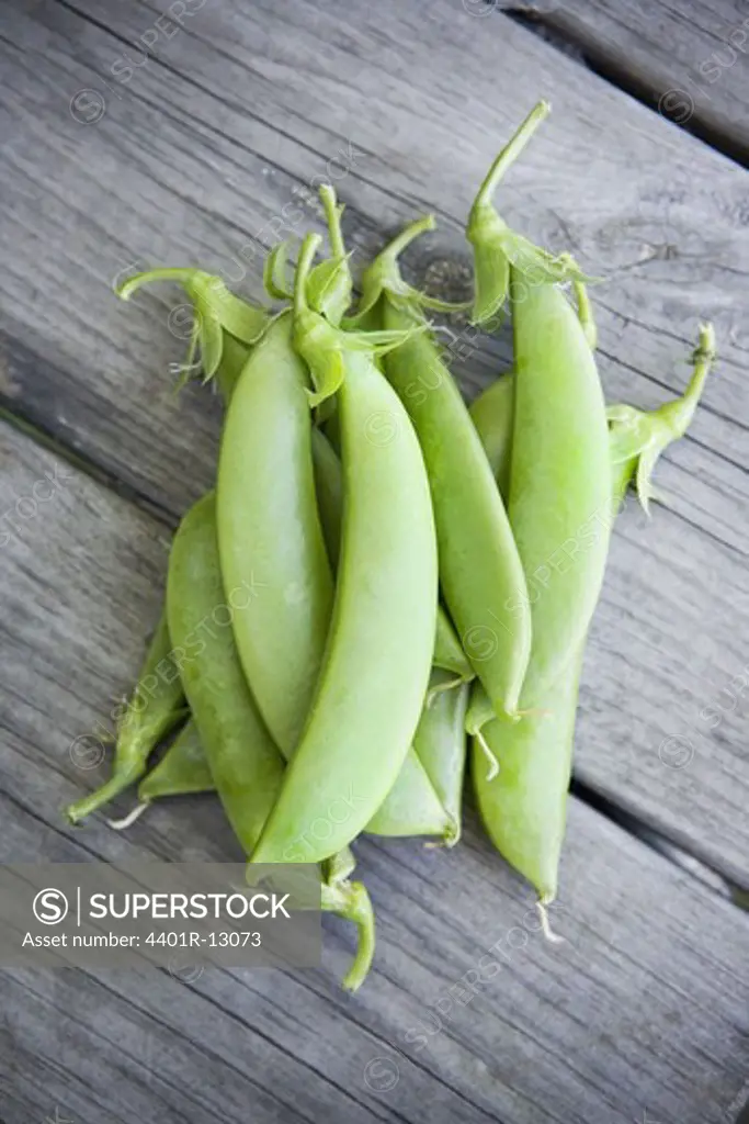 Bunch of sugar peas on plank