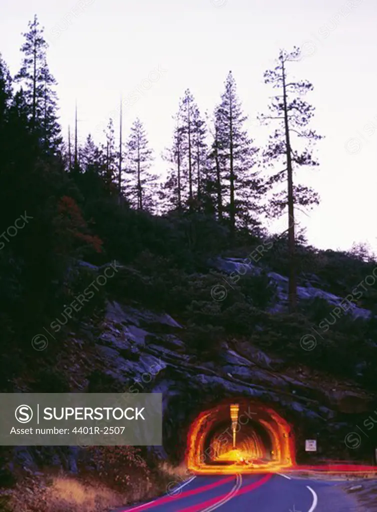 Road leading to tunnel through mountain