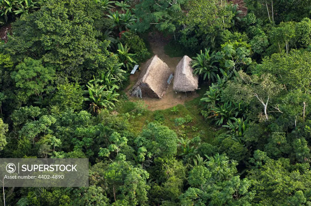 Huaorani Houses seen from the air; simple structures built directly on the ground with a frame made from thin branches covered with palm leaves. Bameno Community, Yasuni National Park, Amazon rainforest, Ecuador, South America.