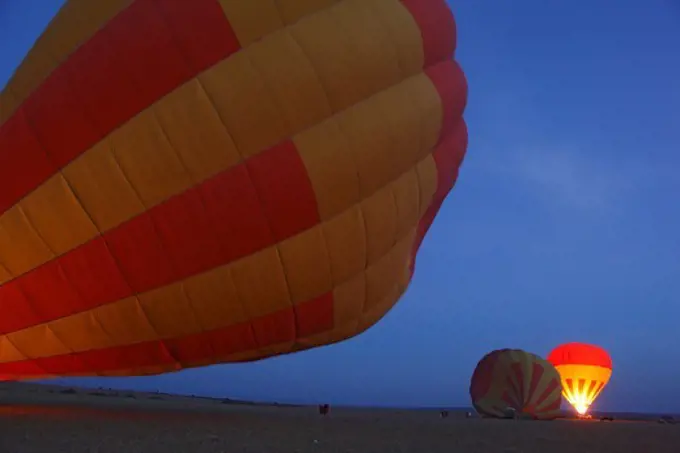 Safari hot-air balloons being inflated, Masai Mara, Kenya