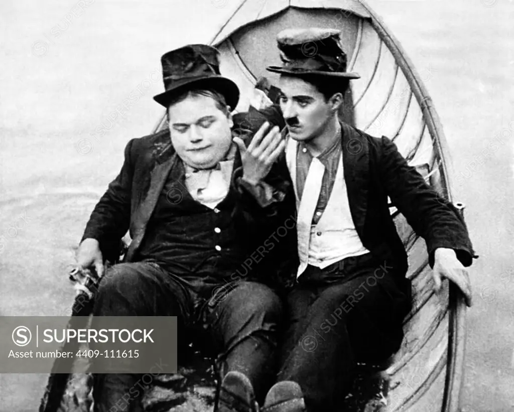 CHARLIE CHAPLIN and ROSCOE "FATTY" ARBUCKLE in THE ROUNDERS (1914), directed by CHARLIE CHAPLIN.