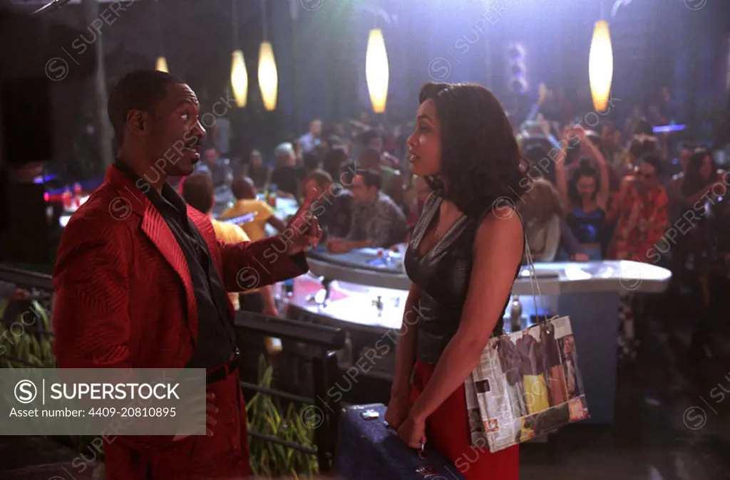 EDDIE MURPHY and ROSARIO DAWSON in THE ADVENTURES OF PLUTO NASH (2002), directed by RON UNDERWOOD.