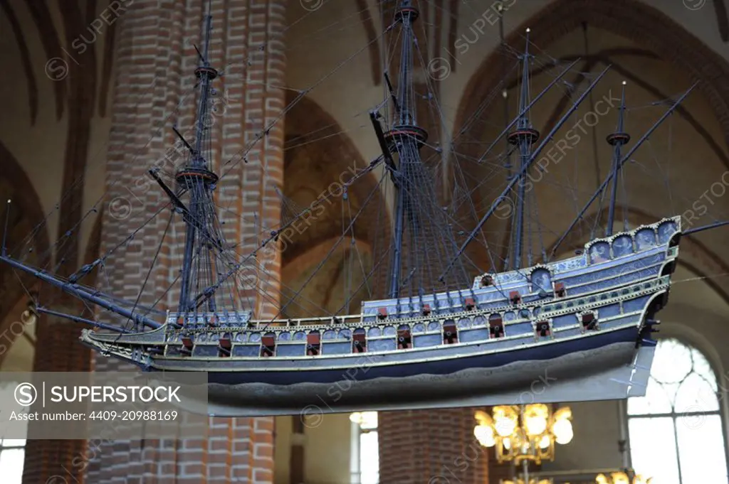 Sweden, Stockholm. English Galleon, 16th century. Votive ship hanging from the ceiling of the Cathedral of Saint Nicholas. One of the oldest votive ships in the world. This ship model is a copy of the original made in 1950s. The original ship model was built around 1600, today kept in the Museum of Maritime History in Stockholm. The ship-type is an Elizabethan galleon, as at the end of the 15th century.