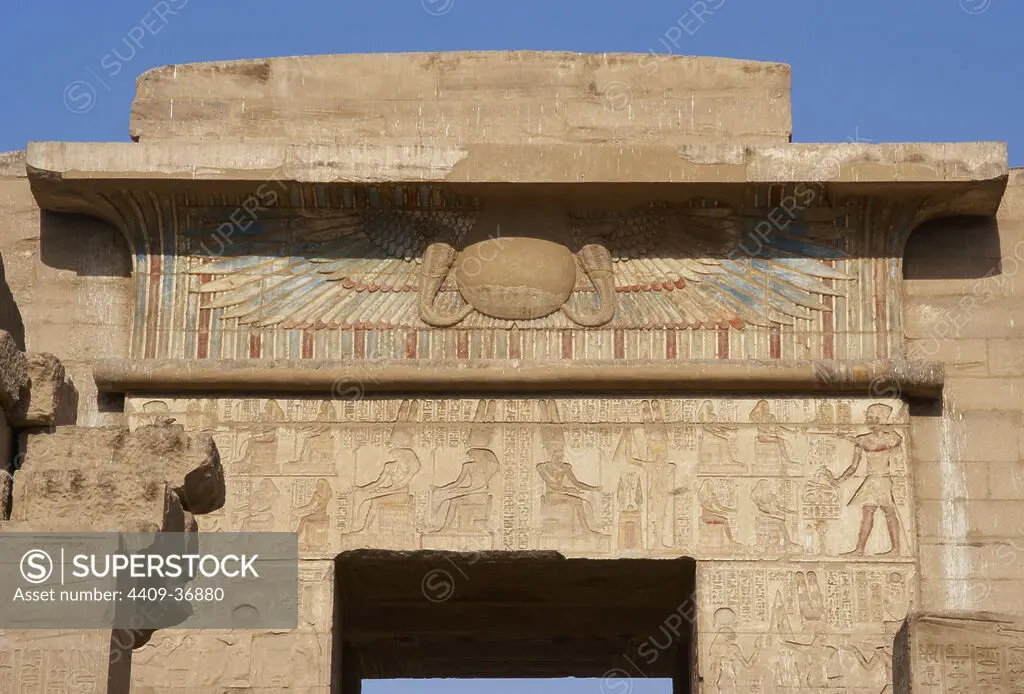 Temple of Ramses III. Winged sun relief (falcon wings with two uraeus and solar disk), as a symbol of protection above the doors of the temples. New Kingdom. (1550-1069 b.C). Twentieth dynasty. Thebes. Medinet-Habou. Egypt.