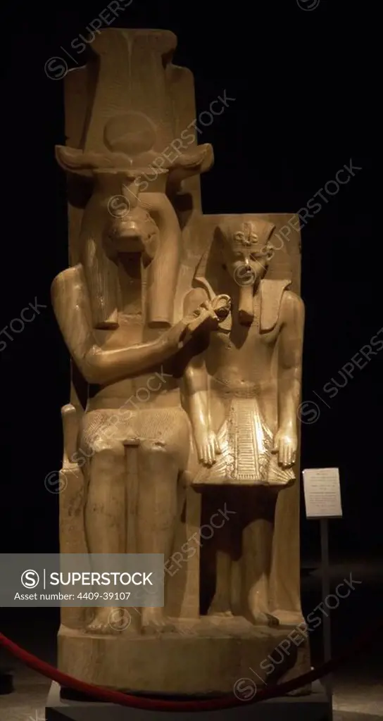 Statue of Amenhotep III (Neb-Maat-Ra) and Sobek c.1390-1352 BC. Carved from Calcite (Egyptian Alabaster). Found in the Sobek temple at Dahamsha. Sobek is seated in a human form with the crocodile head and his right hand holds the Ankh giving life to the youthful Amenhotep III. The King is wearing the Nemes headdress, with the uraeus and royal beard. 18th Dynasty. New Kingdom. Luxor Museum. Egypt.