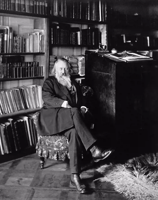 Johannes Brahms, German composer and pianist, at his home, c.1885.