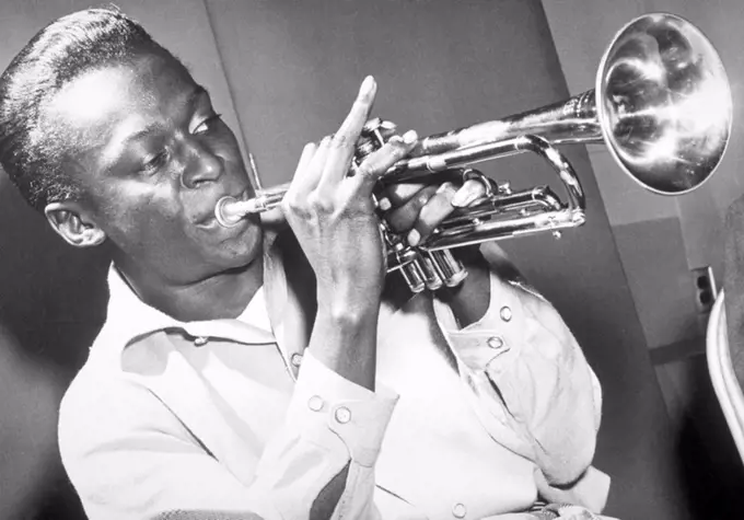 American jazz musician and composer Miles Davis playing the trumpet, 50s.