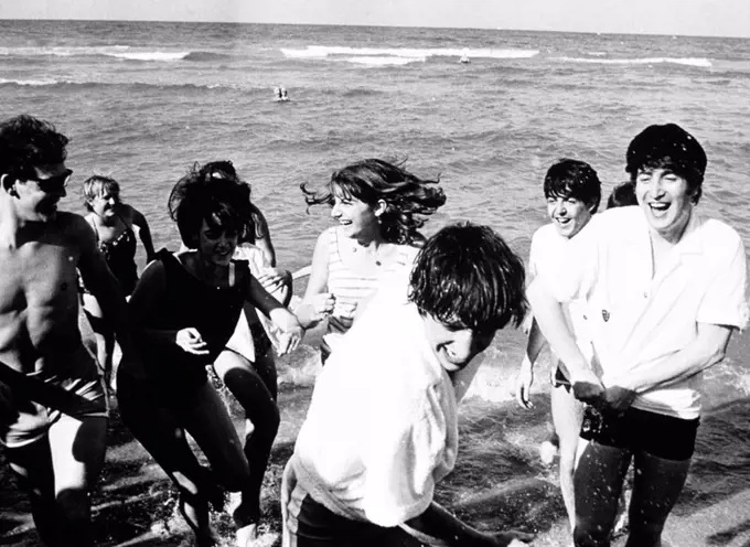 The Beatles on the beach at Miami, 1964. THE BEATLES. RINGO STARR. PAUL MCCARTNEY. JOHN LENNON.