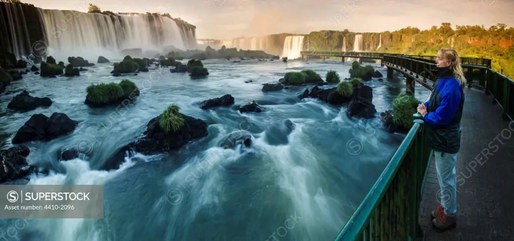 Tourist looking at upper Iguacu Falls, Brazil