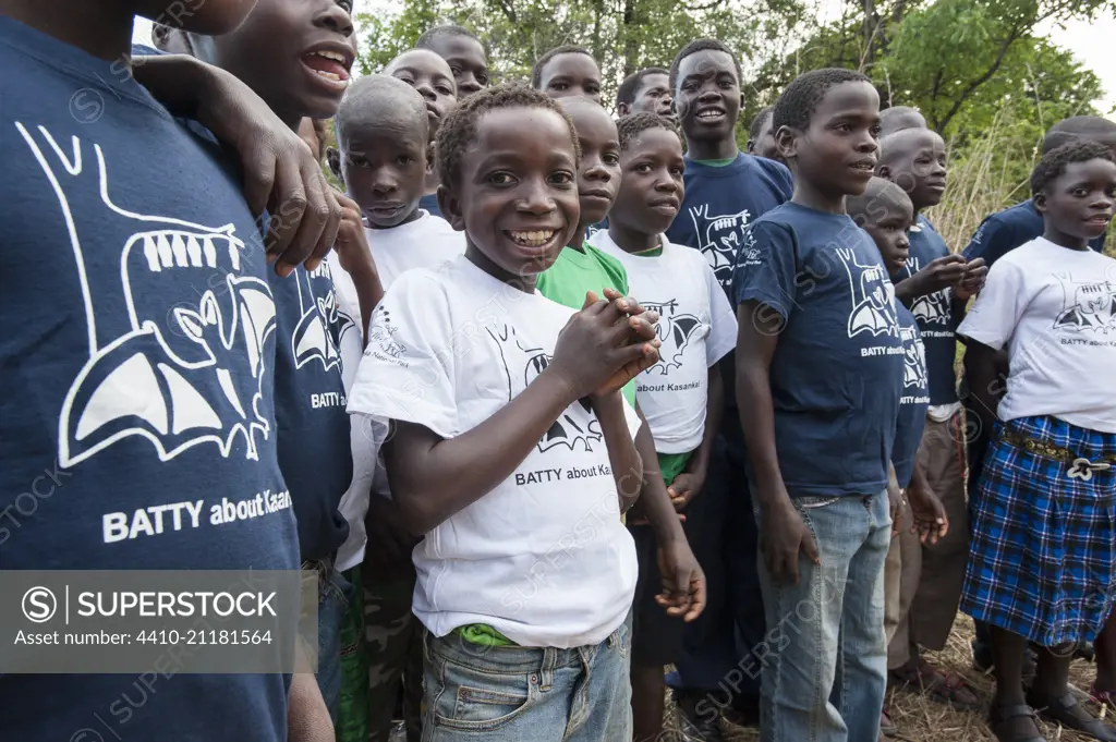 Local school children proudly wearing Kasanka Trust t-shirts on a visit to the Natioanl Park to see the mass aggregations of Straw-coloured Fruit Bat (Eidolon helvum).  Kasanka National Park, Zambia.