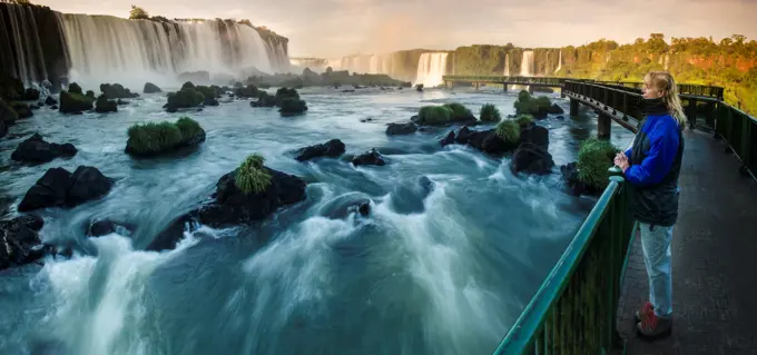 Tourist looking at upper Iguacu Falls, Brazil