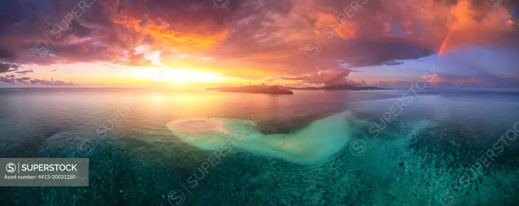 First sunset of the year 2022, a beautiful sunset that occurs just after the passage of storm squalls on the white sand islet of Saziley, Mayotte