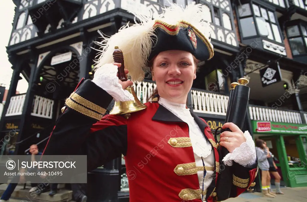 Female town crier ringing a bell, Chester, Cheshire, England