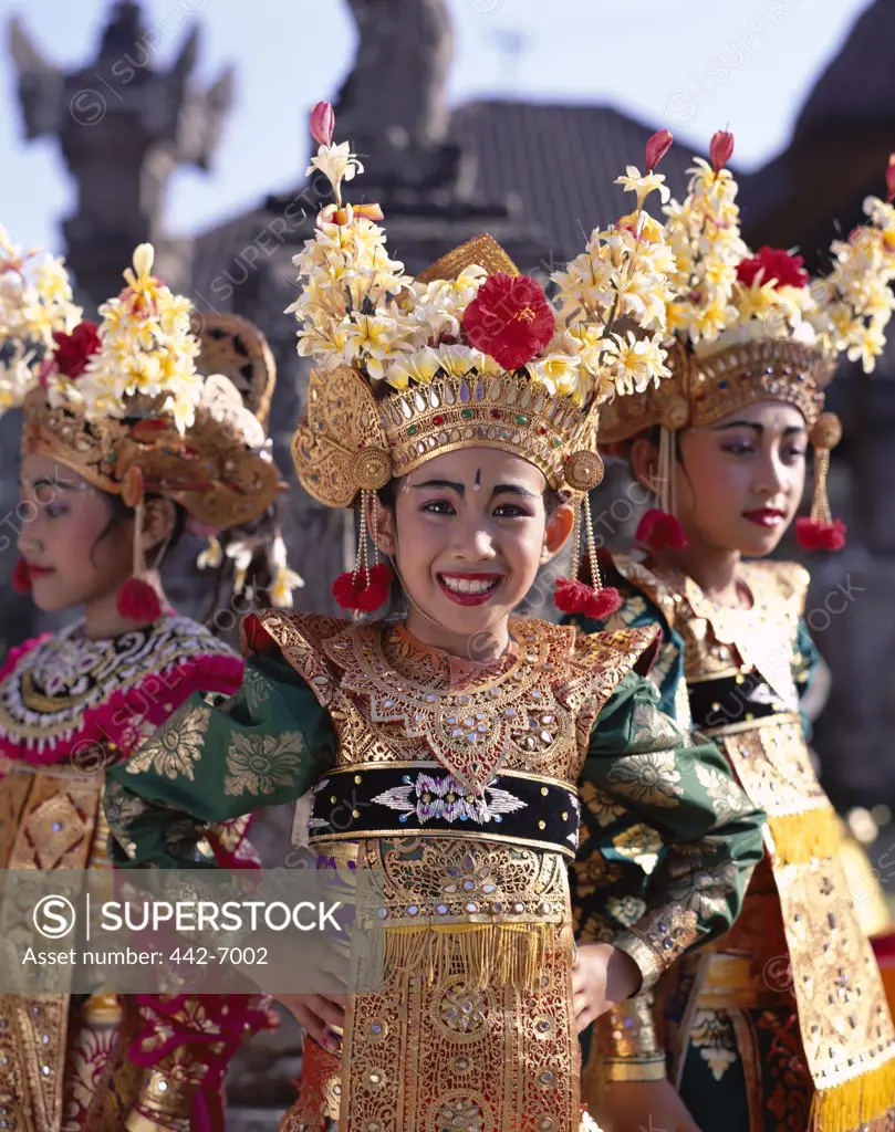 Three Legong dancers dressed in traditional costumes, Bali, Indonesia