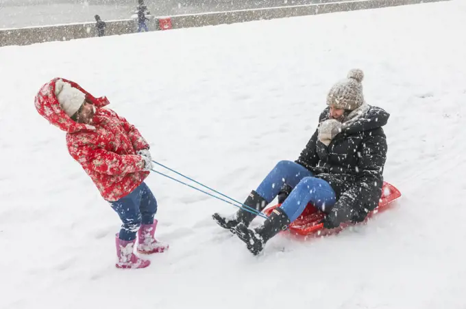 England, London, Southwark, Potters Field, Mother and Child Playing in the Snow 