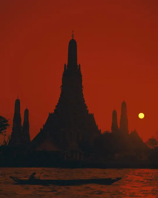 Sunset over a temple, Wat Arun, Chao Phraya River, Bangkok, Thailand